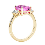 Emerald cut 3 diamond ring representing past, present, and future featuring pink gemstone center.
