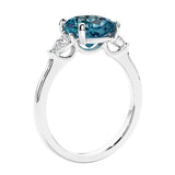 Cushion cut diamond ring as a unique engagement ring featuring three stone design with alexandrite and diamonds.