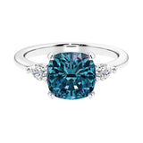 Cushion shaped engagement ring with brilliant diamonds and alexandrite.
