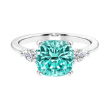 Cushion shaped engagement ring with brilliant diamonds and paraiba tourmaline.