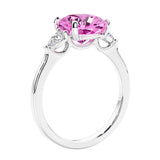 Cushion cut diamond ring as a unique engagement ring featuring three stone design with pink sapphire and diamonds.