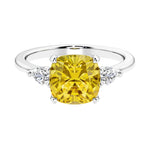 Cushion shaped engagement ring with brilliant diamonds and yellow sapphire.