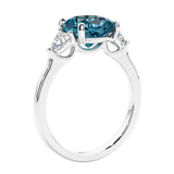 Cushion cut diamond ring as a unique engagement ring featuring three stone design with alexandrite and diamonds.