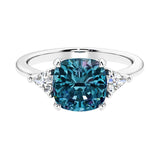 Cushion shaped engagement ring with brilliant diamonds and alexandrite.