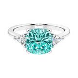 Cushion shaped engagement ring with brilliant diamonds and paraiba tourmaline.