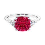 Cushion shaped engagement ring with brilliant diamonds and ruby.