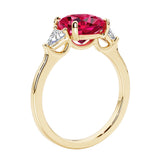 Three stone cushion diamond ring in yellow gold setting with ruby and diamonds.