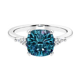 Cushion shaped engagement ring with brilliant diamonds and gemstone.