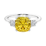 Cushion shaped engagement ring with brilliant diamonds and yellow gemstone.