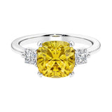 Cushion shaped engagement ring with brilliant diamonds and yellow gemstone.