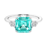 Asscher gemstone diamond ring with step-cut sparkle in a three stone setting.