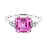 Asscher gemstone diamond ring with step-cut sparkle in a three stone setting.
