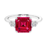 Asscher gemstone diamond ring with step-cut sparkle in a three stone setting.