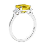 Asscher shaped ring in a timeless three stone ring set with diamond sides.