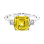 Asscher gemstone diamond ring with step-cut sparkle in a three stone setting.