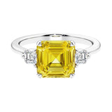 Asscher gemstone diamond ring with step-cut sparkle in a three stone setting.