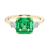 Asscher cut three stone engagement ring with geometric elegance.