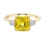 Asscher cut three stone engagement ring with geometric elegance.