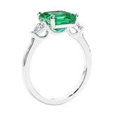 Asscher shaped ring in a timeless three stone ring set with diamond sides and colombian emerald center.