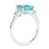 Asscher shaped ring in a timeless three stone ring set with diamond sides and paraiba tourmaline center.