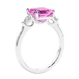 Asscher shaped ring in a timeless three stone ring set with diamond sides and pink sapphire center.