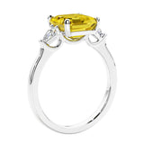 Asscher shaped ring in a timeless three stone ring set with diamond sides and yellow sapphire center.
