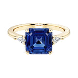 Asscher cut three stone engagement ring with geometric elegance.