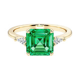 Asscher cut three stone engagement ring with geometric elegance.