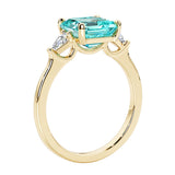 3 stone Asscher cut gemstone diamond ring in a classic Art Deco style featuring a paraiba tourmaline center.