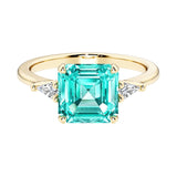 Asscher cut three stone engagement ring with geometric elegance.