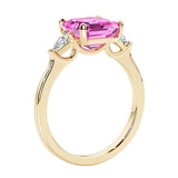 3 stone Asscher cut gemstone diamond ring in a classic Art Deco style featuring a pink sapphire center.