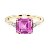 Asscher cut three stone engagement ring with geometric elegance.