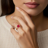 Woman wearing a 3 stone Asscher engagement ring with vintage flair featuring a ruby center.