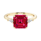 Asscher cut three stone engagement ring with geometric elegance.