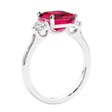Asscher shaped ring in a timeless three stone ring set with diamond sides and ruby center.