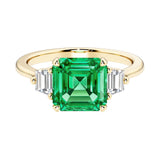 Asscher cut three stone engagement ring with geometric elegance.