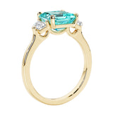 3 stone Asscher cut gemstone diamond ring in a classic Art Deco style featuring a paraiba tourmaline center.