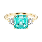 Asscher cut three stone engagement ring with geometric elegance.