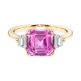 Asscher cut three stone engagement ring with geometric elegance.