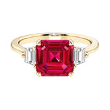 Asscher cut three stone engagement ring with geometric elegance.