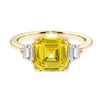 Asscher cut three stone engagement ring with geometric elegance.
