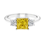 3 stone princess diamond ring in sleek white gold with yellow sapphire gemstone.