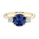 Three stone round engagement ring with brilliant cut diamonds.