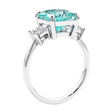 Engagement ring with princess cut diamonds in a 3 stone design featuring paraiba tourmaline gemstone center.