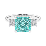 3 stone princess diamond ring in sleek white gold with paraiba tourmaline gemstone center.