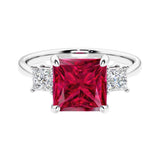 3 stone princess diamond ring in sleek white gold with ruby gemstone center.