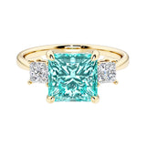 Princess cut 3 stone engagement ring with square side diamonds and paraiba tourmaline gemstone center.