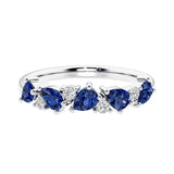 Elegant anniversary ring with 9 alternating pear shaped blue sapphires and brilliant round diamonds.