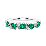 Elegant anniversary ring with 9 alternating pear shaped green emeralds and brilliant round diamonds.