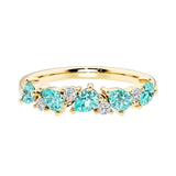 9-stone gemstone anniversary band featuring pear-cut paraiba tourmalines and round diamonds for a magical, color-shifting effect.